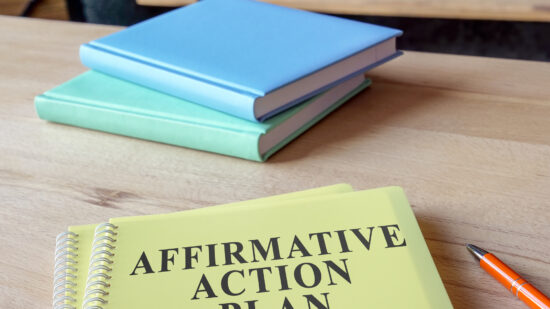 Affirmative Action Plan AAP with other papers on the desk.